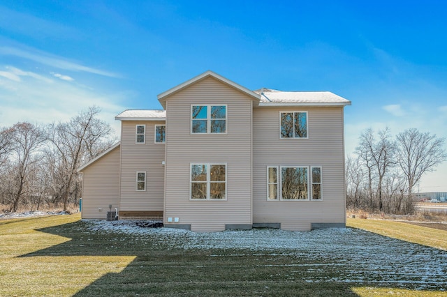 rear view of house featuring a yard and central AC unit