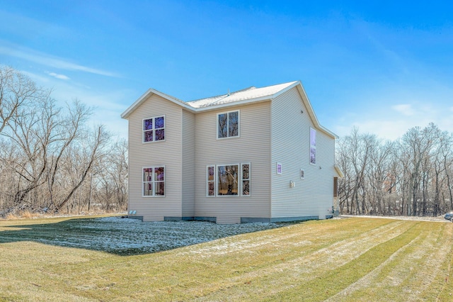 view of side of property with a lawn