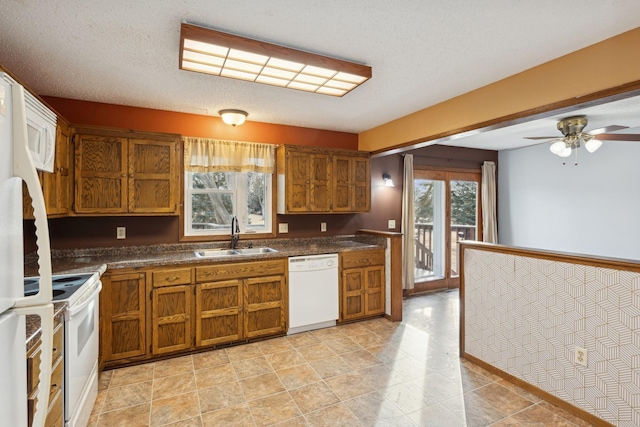 kitchen with sink, white appliances, a textured ceiling, and ceiling fan