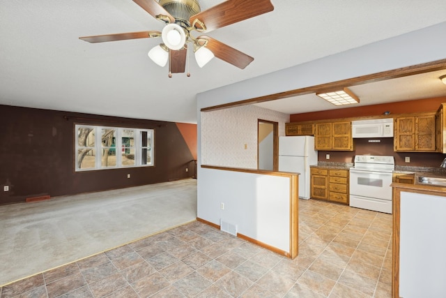 kitchen with ceiling fan, white appliances, sink, and light carpet