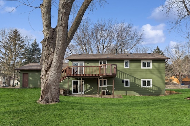 back of house featuring a wooden deck and a yard