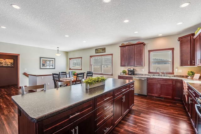 kitchen featuring a kitchen island, dark wood finished floors, dishwasher, recessed lighting, and a sink