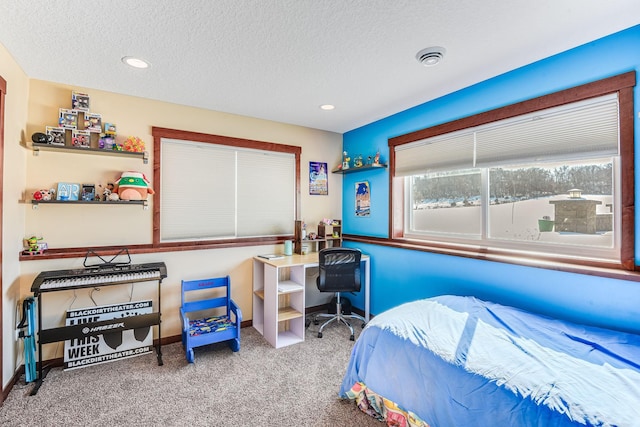 carpeted bedroom with recessed lighting, baseboards, and a textured ceiling