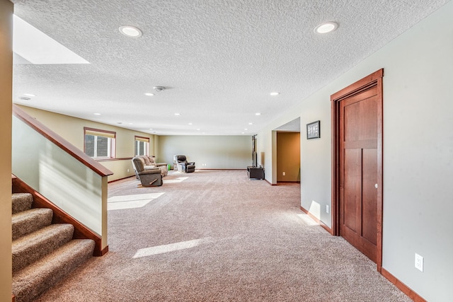 interior space featuring carpet, baseboards, recessed lighting, stairs, and a textured ceiling