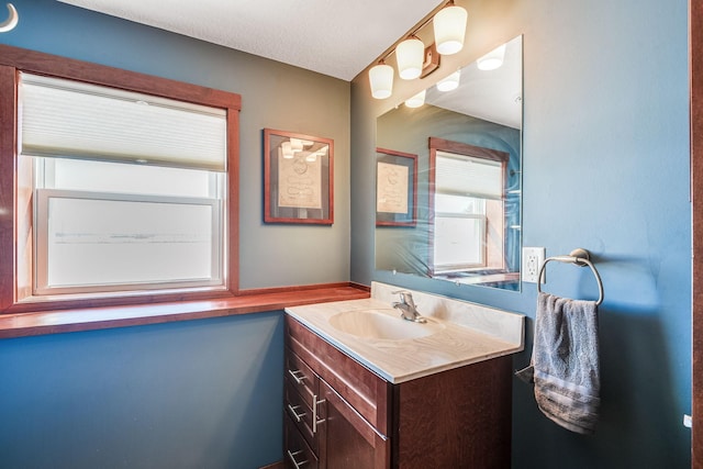 bathroom featuring a textured ceiling and vanity