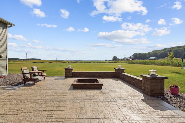 view of patio / terrace featuring a rural view and an outdoor fire pit