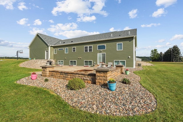 back of house featuring a patio and a lawn