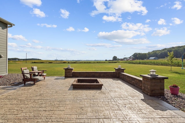 view of patio / terrace featuring a rural view and a fire pit