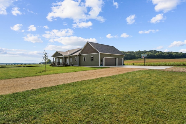 view of front of house featuring a front lawn, a rural view, a garage, and dirt driveway