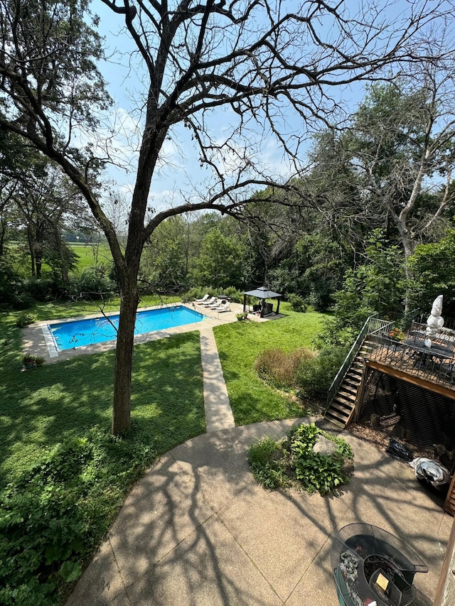 exterior space featuring a gazebo, a lawn, a patio area, and a fire pit