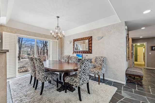 dining space with plenty of natural light and a chandelier