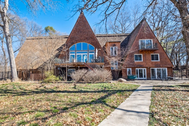 view of front facade with a patio, a deck, and a front lawn