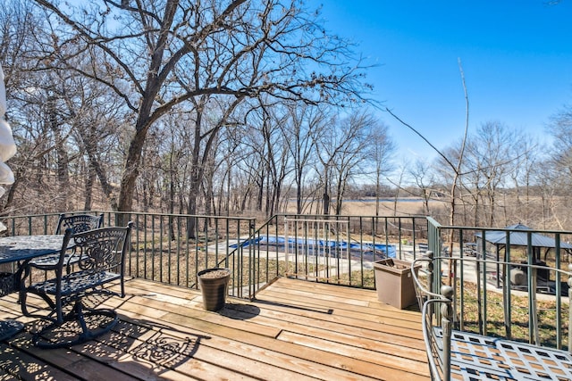 wooden terrace featuring a covered pool