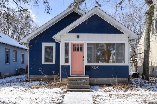 bungalow-style home with central AC unit