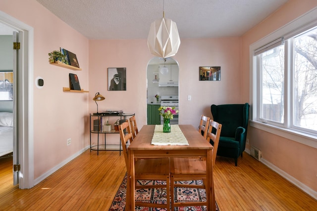 dining area featuring light hardwood / wood-style floors and a textured ceiling