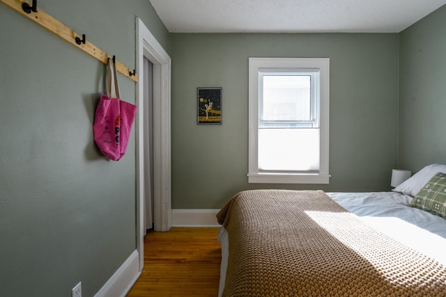 bedroom with hardwood / wood-style flooring