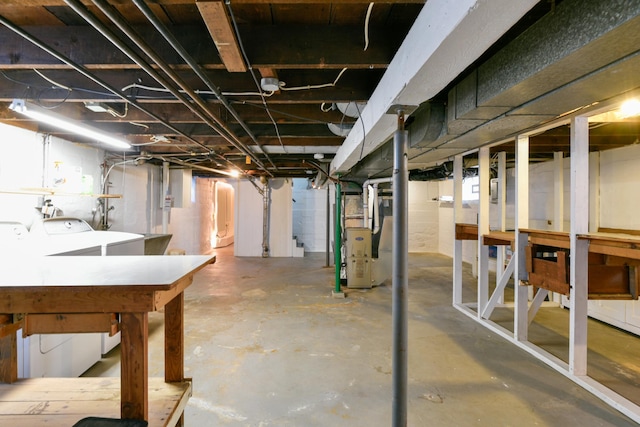 basement with washer and clothes dryer and heating unit