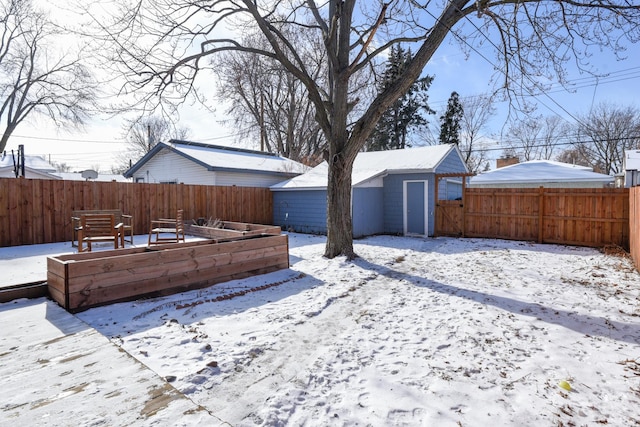 yard layered in snow featuring an outbuilding