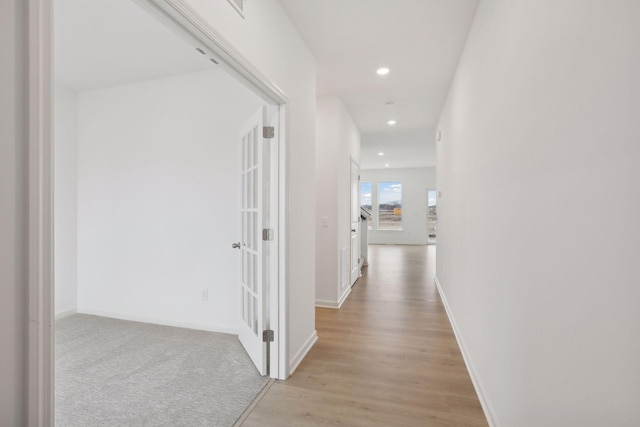 hall with light hardwood / wood-style floors