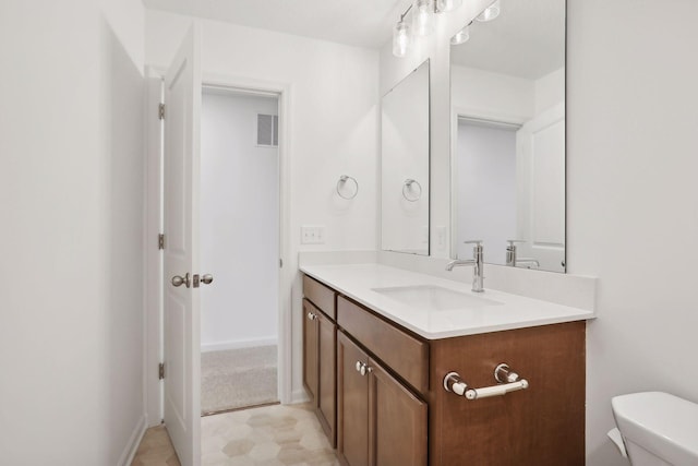 bathroom featuring vanity and toilet