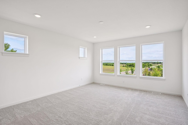 carpeted empty room featuring a healthy amount of sunlight