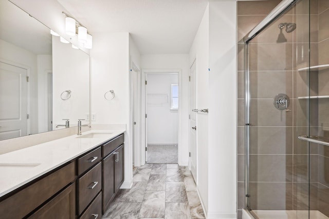 bathroom with vanity and a shower with shower door