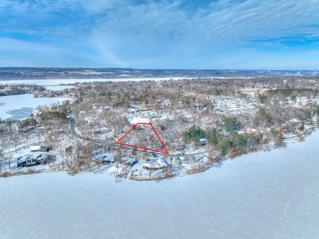 snowy aerial view with a water view