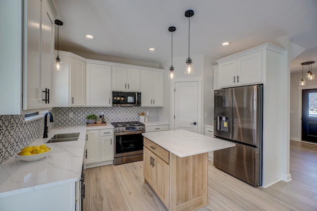 1205 Riverside Dr N, North Hudson, WI 54016 - kitchen featuring appliances with stainless steel finishes, a sink, light wood-style flooring, tasteful backsplash, and recessed lighting