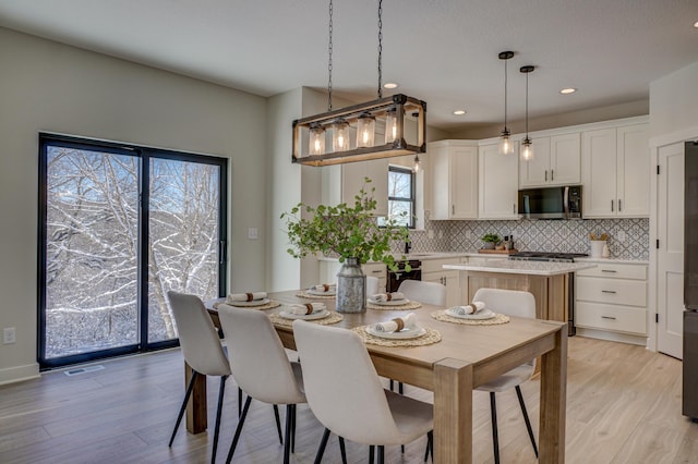 1205 Riverside Dr N, North Hudson, WI 54016 - dining space featuring light wood-style floors and recessed lighting