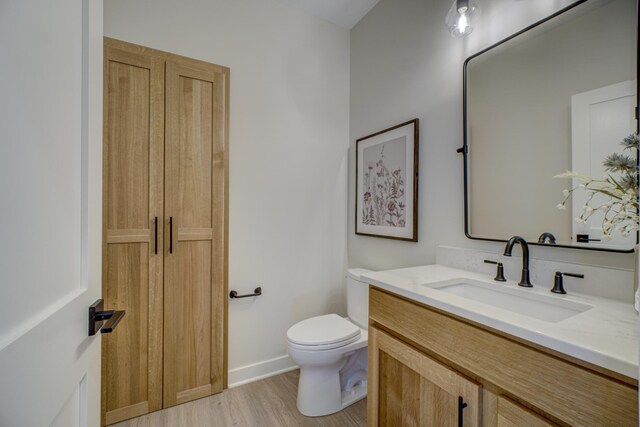 1205 Riverside Dr N, North Hudson, WI 54016 - bathroom with toilet, wood finished floors, vanity, and baseboards