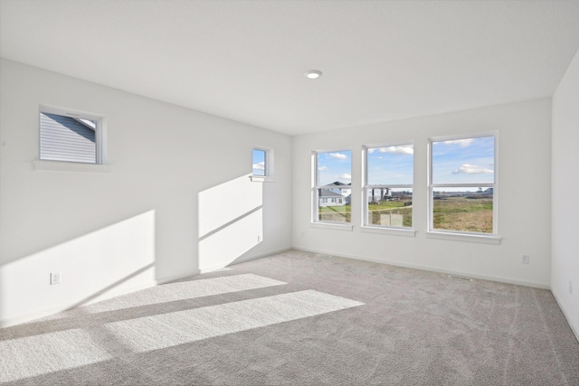 spare room featuring light colored carpet