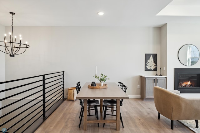 dining area featuring an inviting chandelier and light wood-type flooring