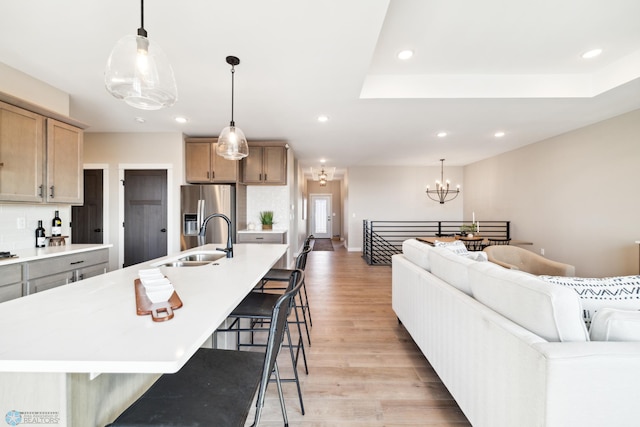 kitchen featuring sink, stainless steel fridge, and a spacious island