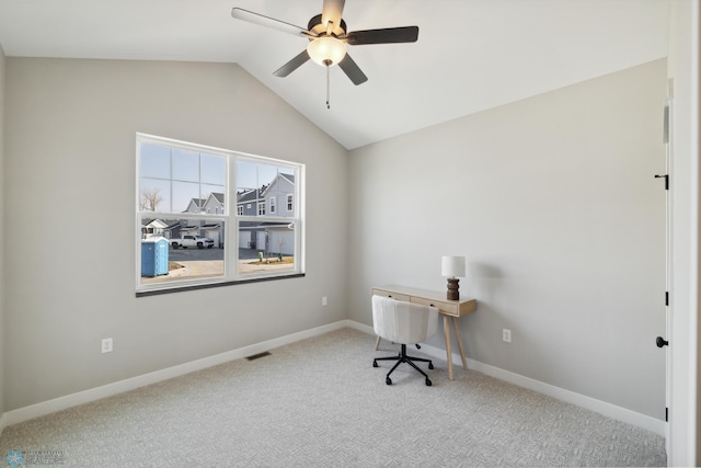 unfurnished office with lofted ceiling, ceiling fan, and carpet