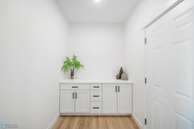 bar with light wood-type flooring and baseboards