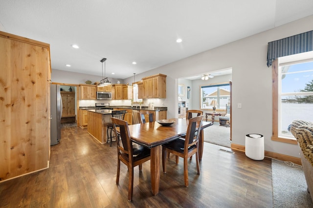 dining room featuring plenty of natural light, dark hardwood / wood-style floors, and ceiling fan