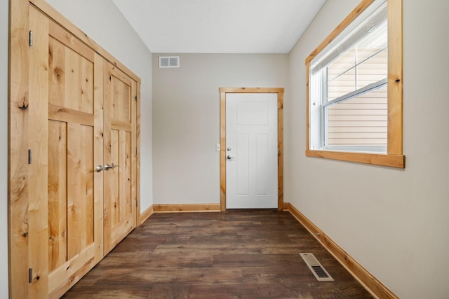 doorway to outside with dark wood-type flooring