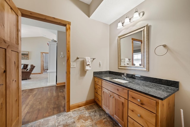 bathroom with vanity and lofted ceiling