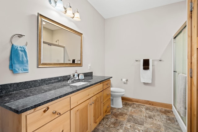 bathroom with vanity, an enclosed shower, and toilet