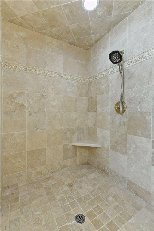 bathroom with tiled shower