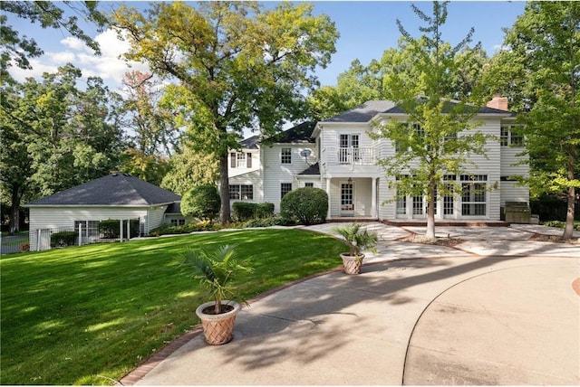 view of front of home with french doors and a front lawn