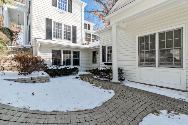 view of snow covered rear of property