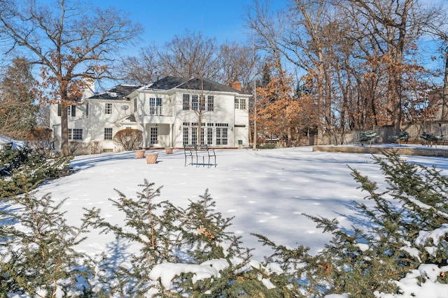 view of snow covered rear of property