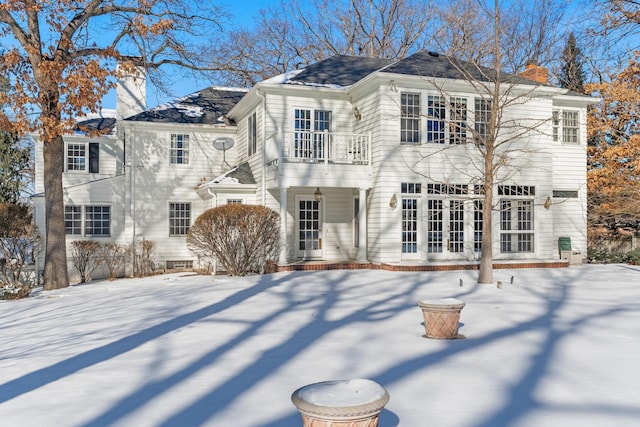 view of front of home featuring french doors and a balcony