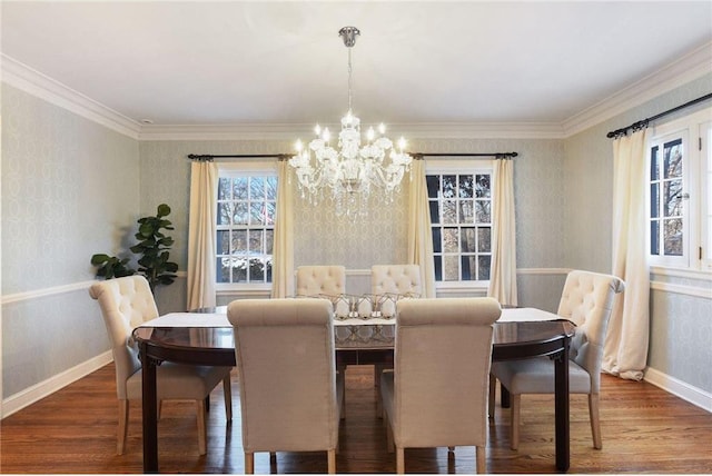dining space featuring baseboards, wood finished floors, a notable chandelier, and wallpapered walls