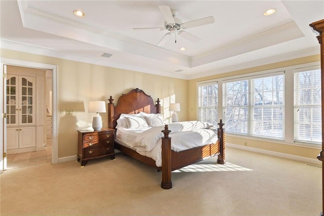 bedroom with a raised ceiling, ornamental molding, light carpet, and recessed lighting