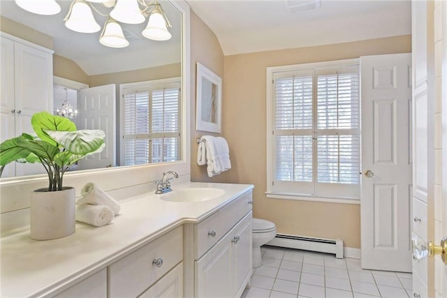 bathroom featuring an inviting chandelier, tile patterned flooring, baseboard heating, and a healthy amount of sunlight