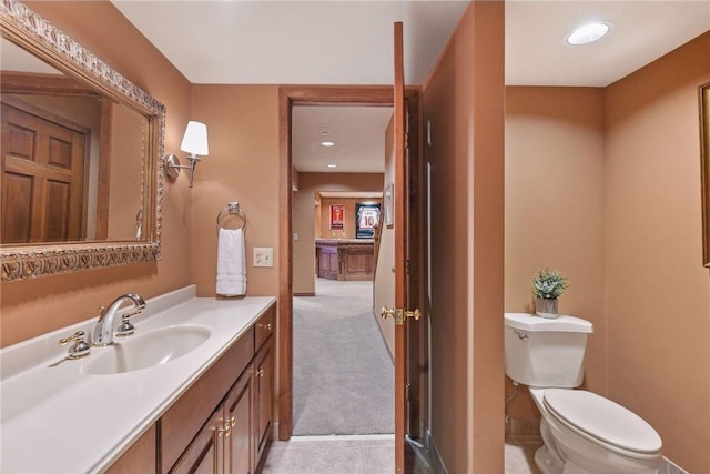 bathroom featuring recessed lighting, vanity, and toilet