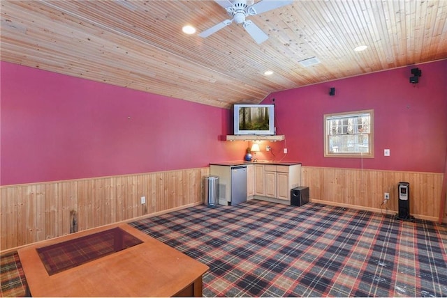 interior space featuring wooden walls, wood ceiling, a wainscoted wall, a ceiling fan, and vaulted ceiling