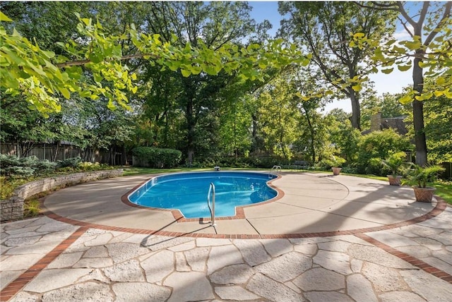 view of pool featuring a fenced backyard, a fenced in pool, and a patio area